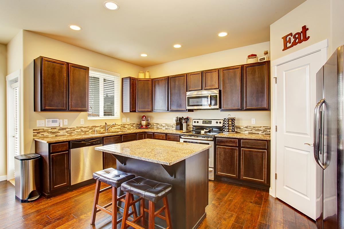 Granite kitchen countertop paired with dark brown cabinets